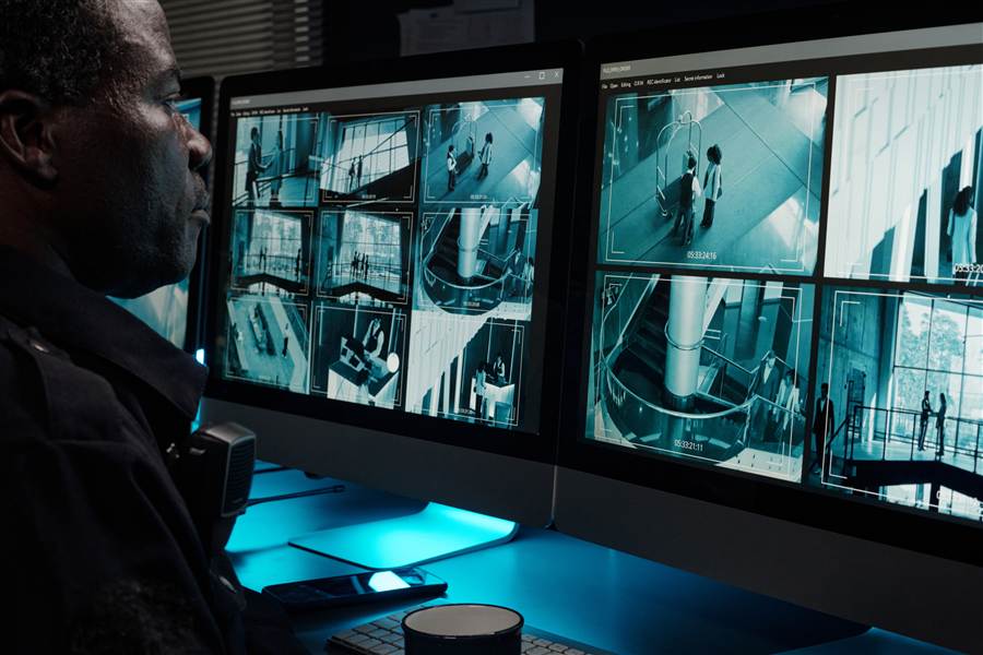 Security staff monitoring camera surveillance feeds