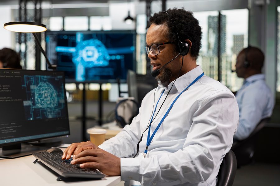IT technician on a headset call coordinating vendor support